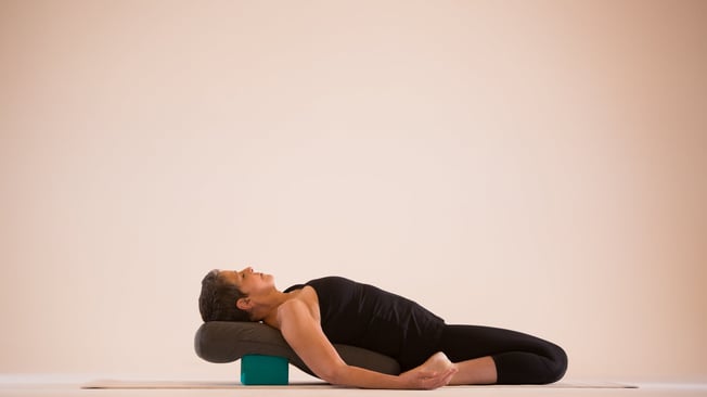 supta-virasana-hero-pose-over-bolster-7aefa86c7c87ade5fb10870979b60590